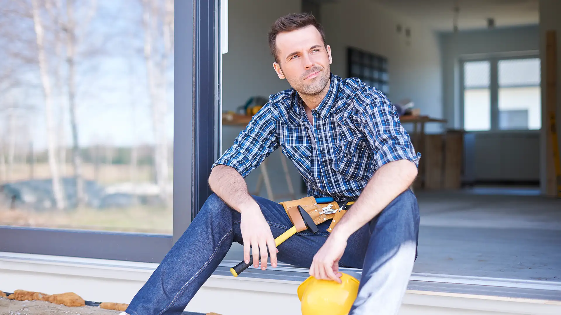 Professional handyman in Central London repairing a door for residential property