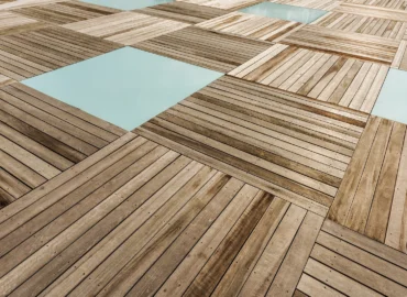 Installer fitting premium herringbone wooden floor in a bright London living room, showcasing luxury flooring services London quality and detail.