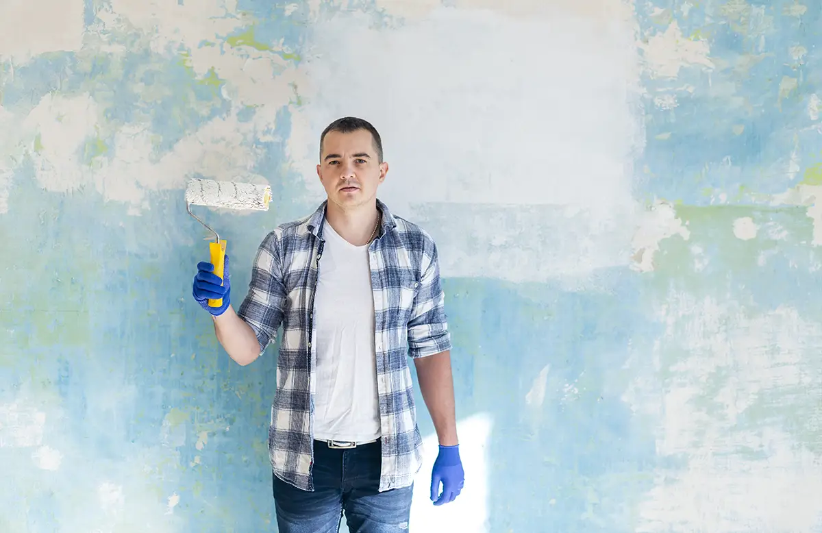 Professional painter decorating interior walls in a modern home