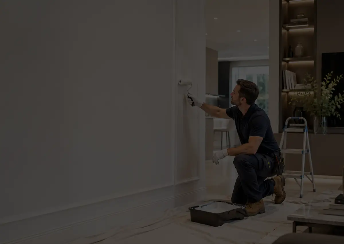 Professional decorator painting a modern home interior with a clean finish